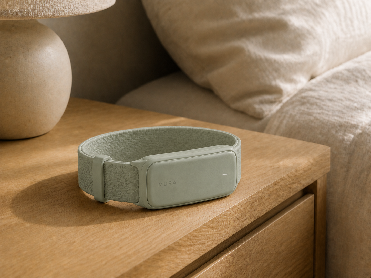 Sage Mura Band resting on a wooden bedside table