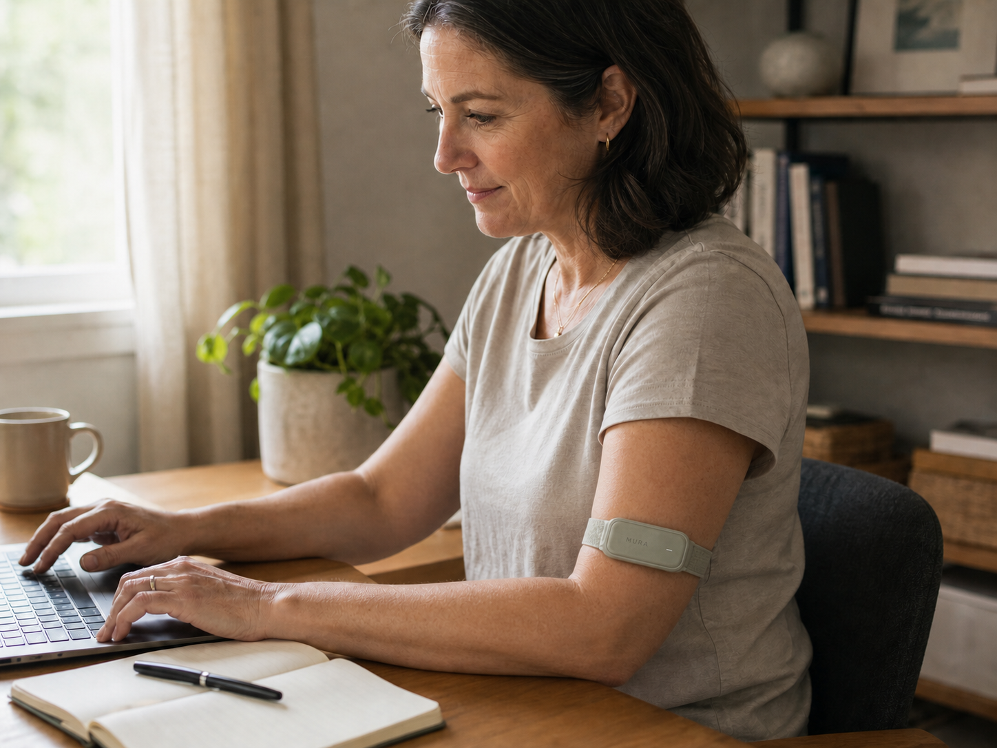 A woman wearing a Sage Mura Band while working at a desk